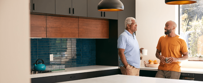 Dad and son in discussing new cabinet installation.