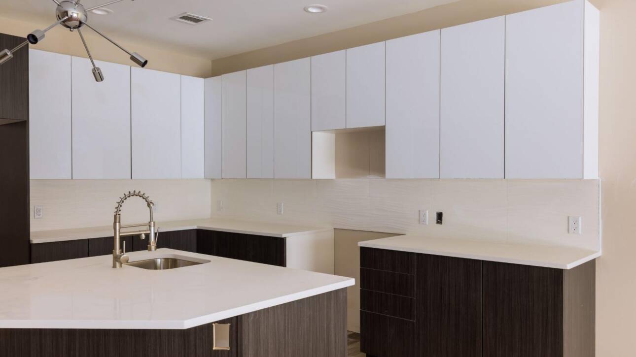 Upgrading kitchen with new sink tap set in a freshly installed modern cabinet.