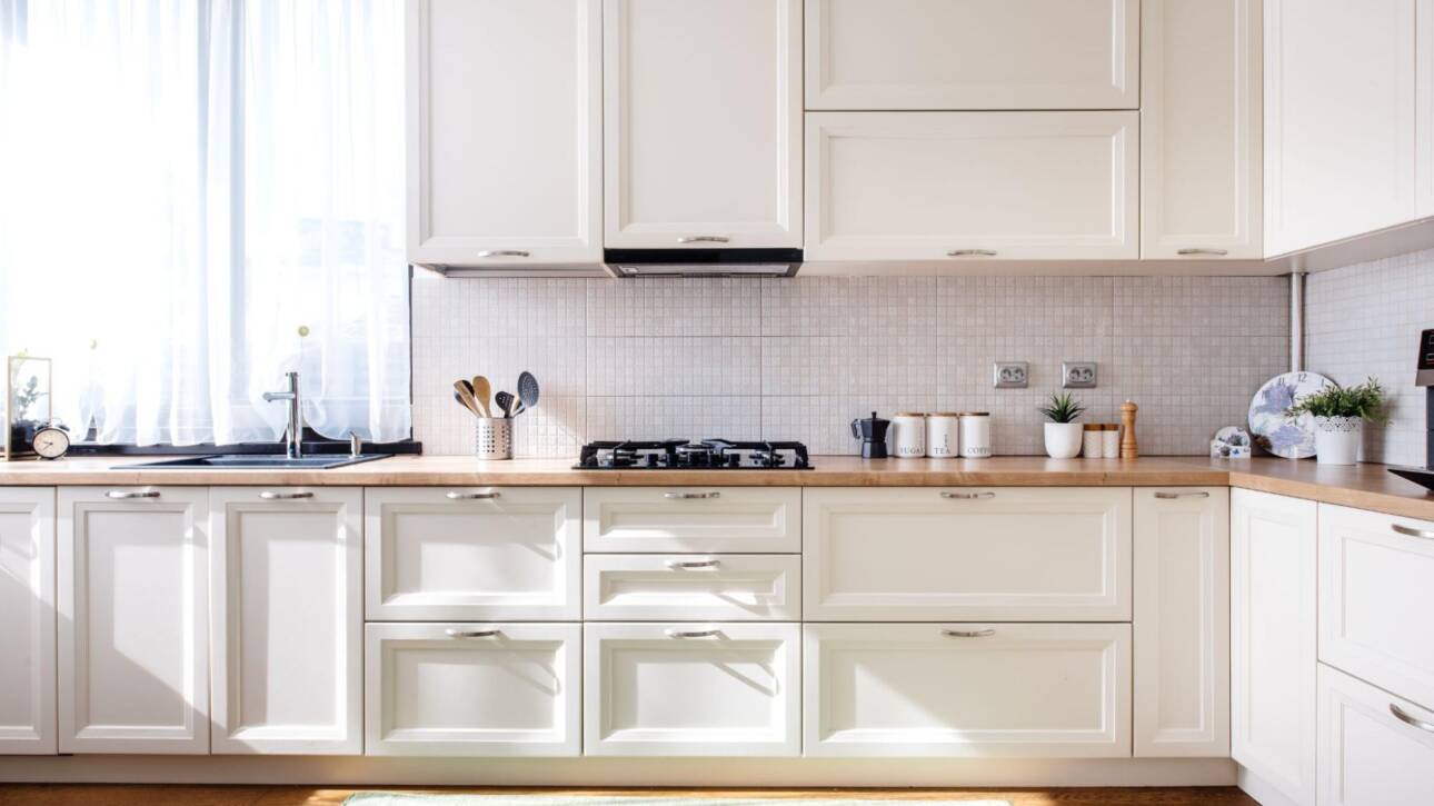 Modern kitchen interior with white Shaker-style wood cabinet doors