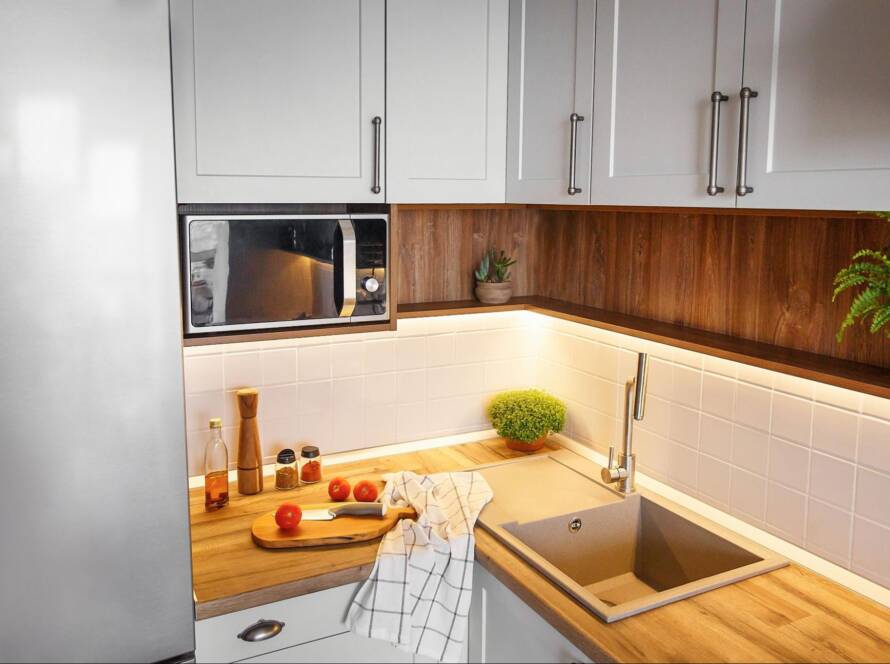 Modern wood corner cabinets next to a microwave, fridge, and sink.