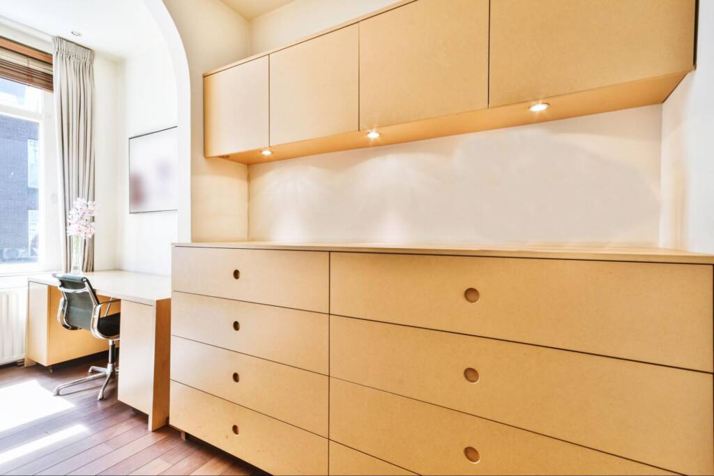 Modern apartment with sleek, minimalist wooden cabinets.