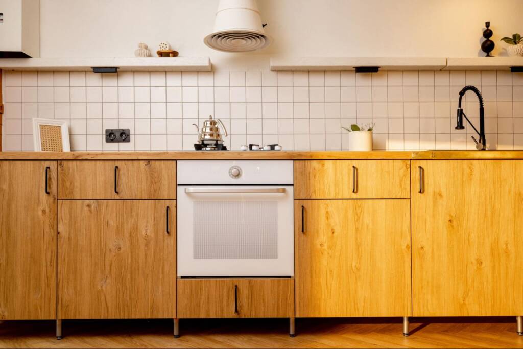 Stylish wooden kitchen cabinet design with a built-in oven centerpiece.